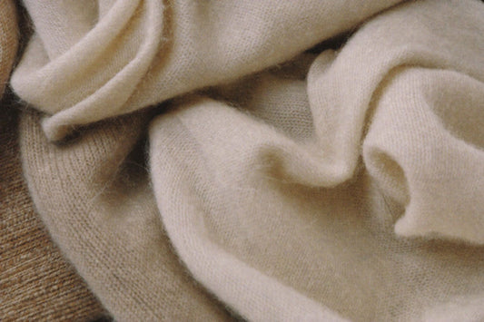 Neatly folded neutral clothing in soft daylight
