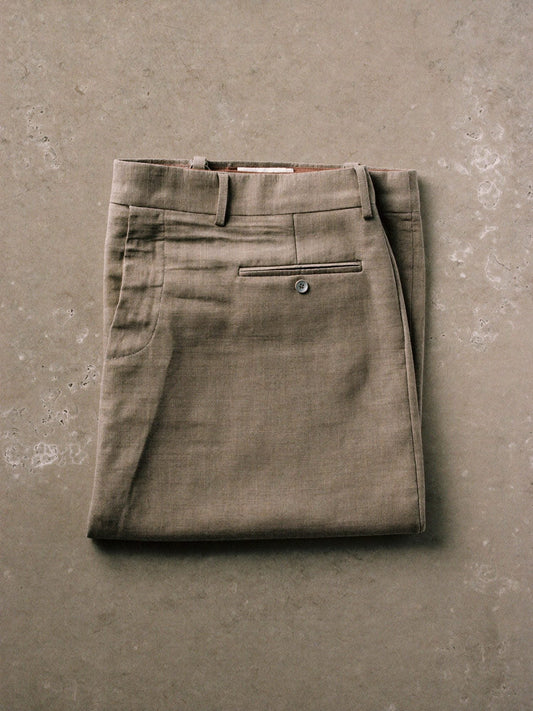 Folded neutral trousers laid flat